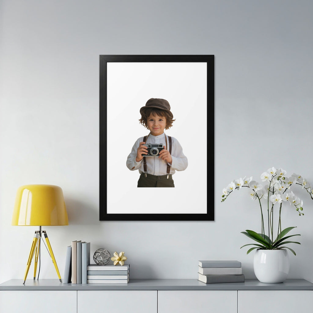 Boy in cap and suspenders holds vintage camera in a framed picture.