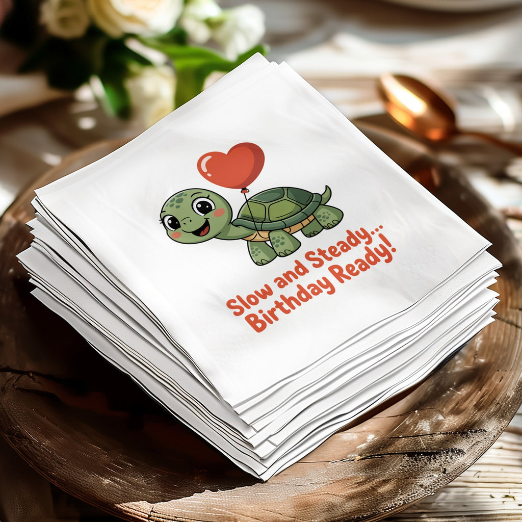 Stack of white napkins featuring a cartoon turtle and "Slow and Steady... Birthday Ready!" text.