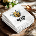 Napkins with a cartoon bee and "Buzzing into 21" text.