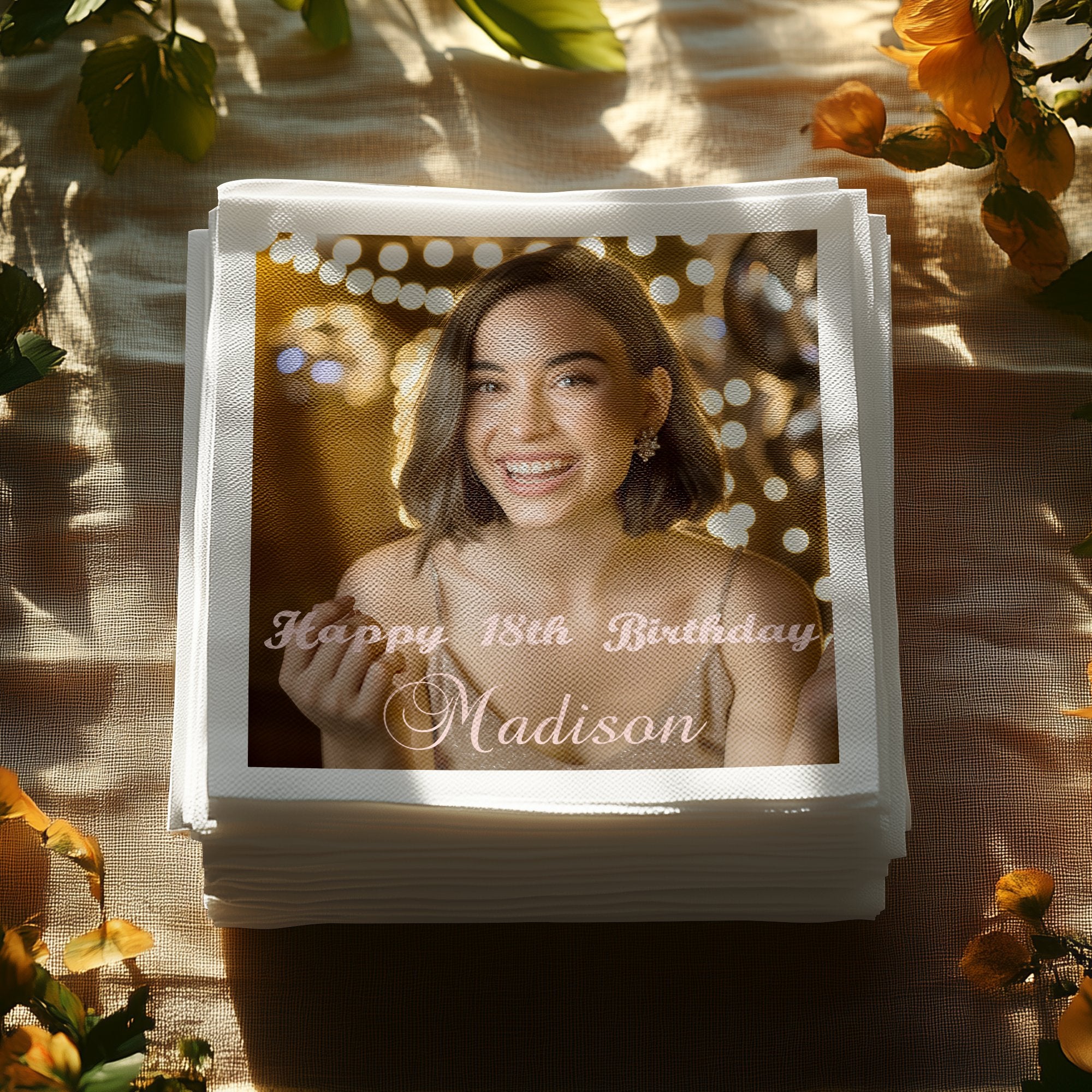 Stack of napkins with "Happy 18th Birthday, Madison" text and a smiling person's photo.