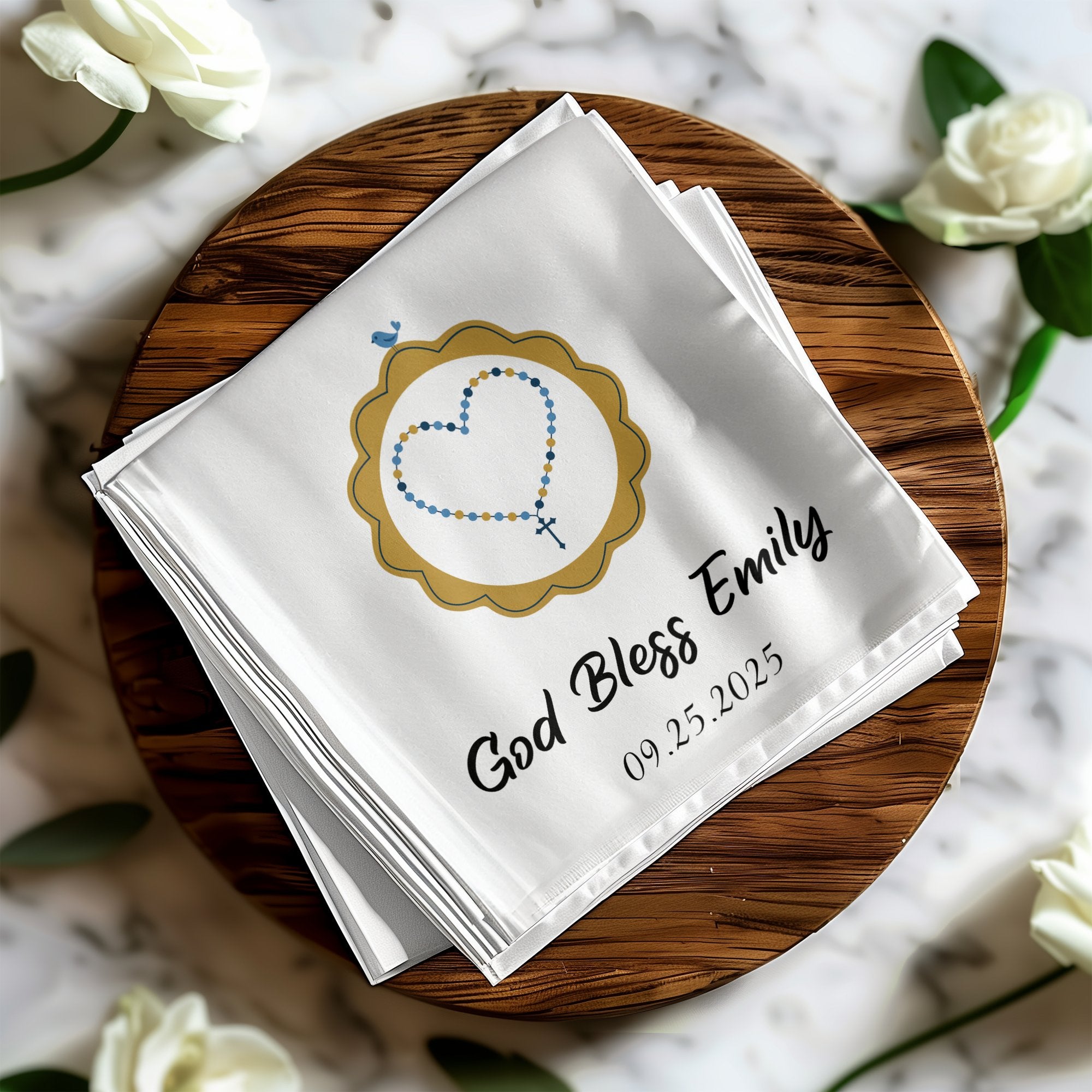 White cloth with "God Bless Emily" and 09.25.2025, framed by a rosary heart.