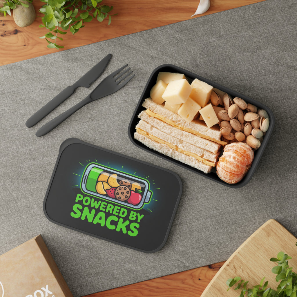 Lunchbox with battery icon, fruit, and text "POWERED BY SNACKS" next to food.