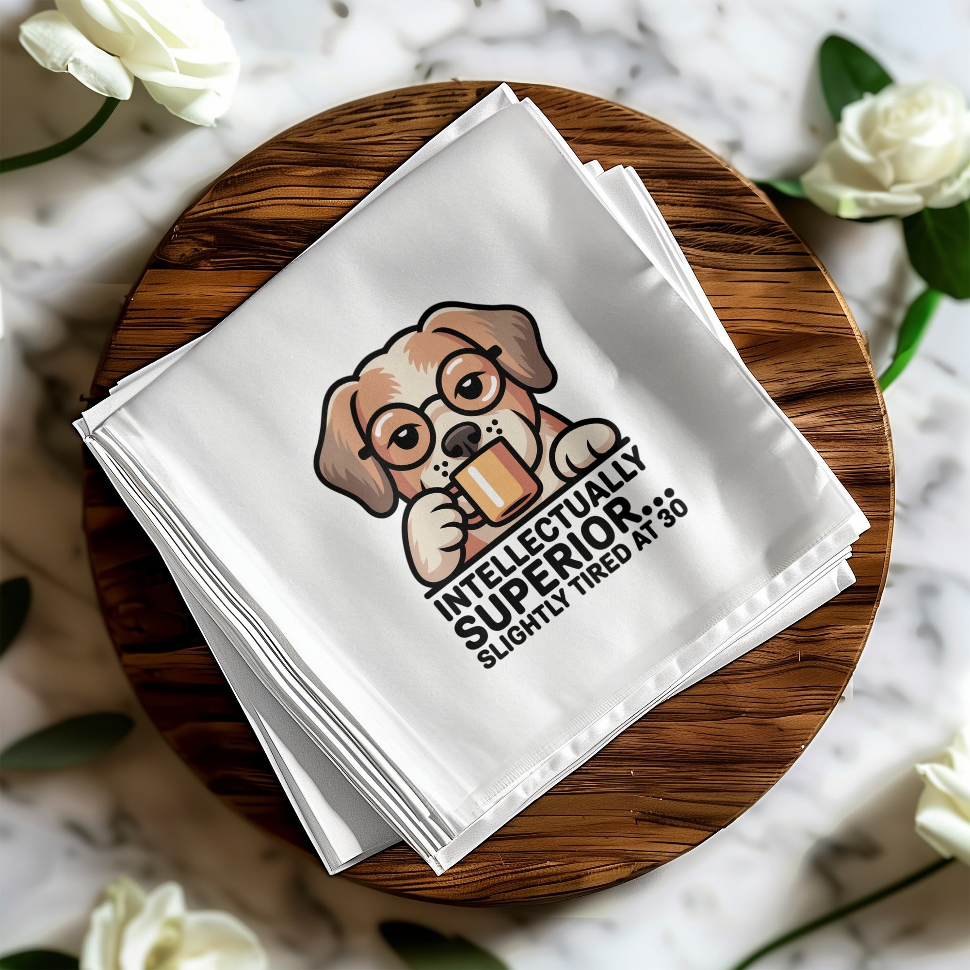 White napkin with cartoon dog wearing glasses holding mug, text reads "INTELLECTUALLY SUPERIOR, SLIGHTLY TIRED AT 30".