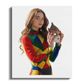 Woman in colorful harlequin costume holding a Venetian mask.