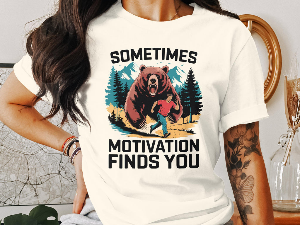 Man running from a bear with text "Sometimes Motivation Finds You."