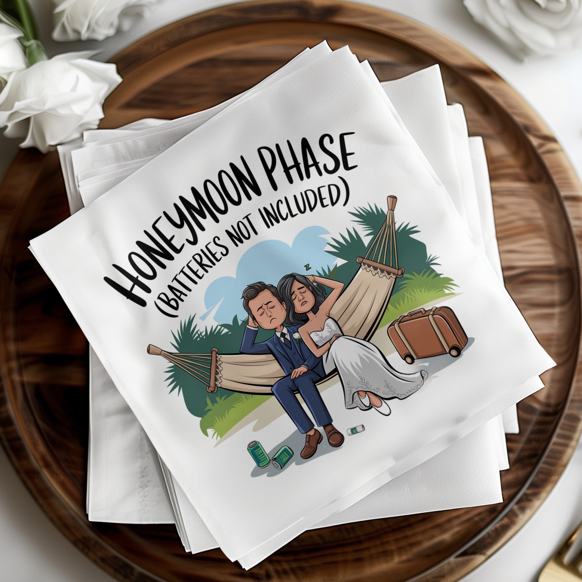 Napkins with cartoon of exhausted bride and groom in hammock, text reads "Honeymoon Phase (Batteries not included)".