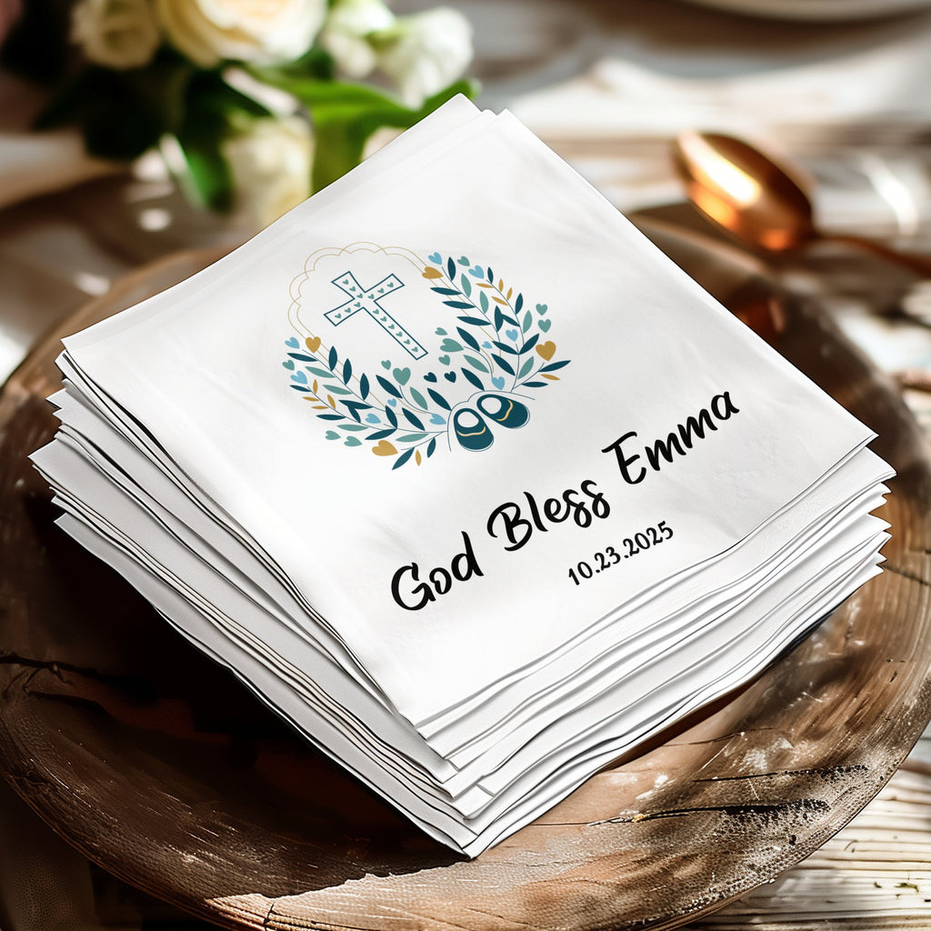 White personalized baptism napkins with "God Bless Emma" and date.