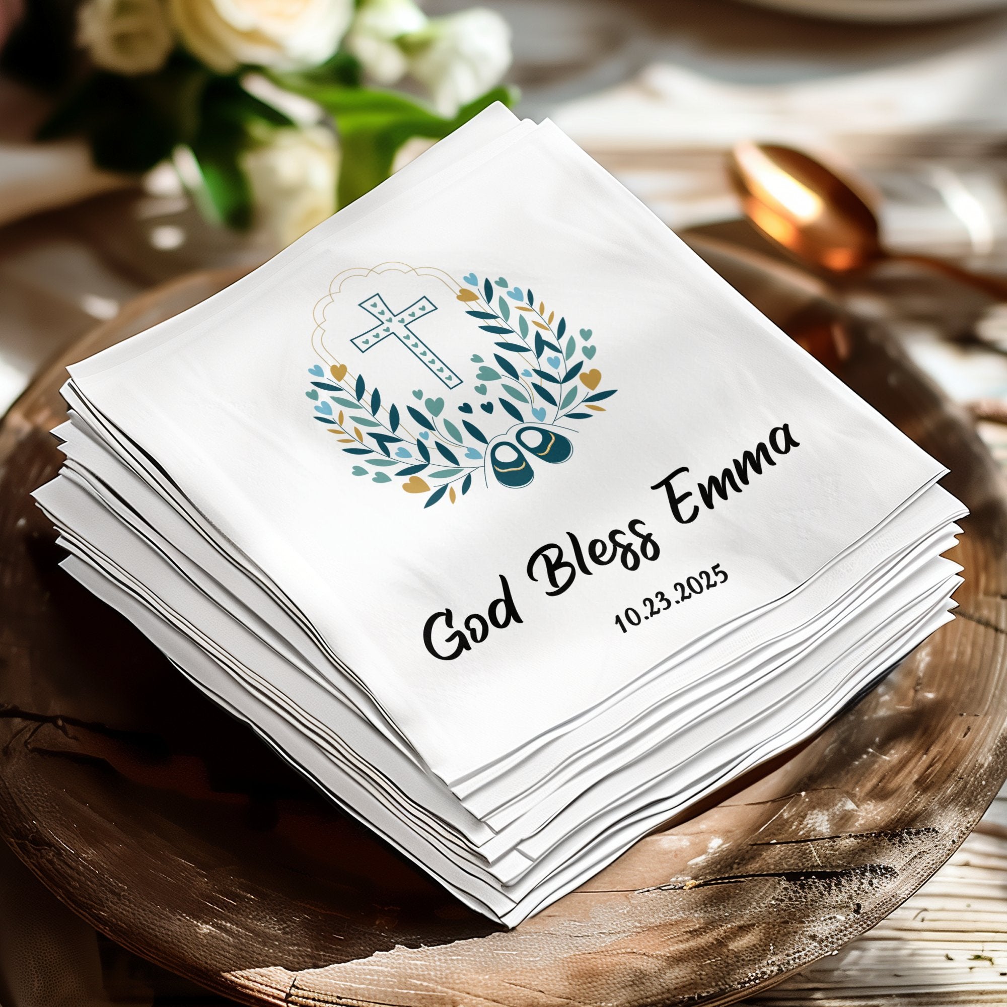 White personalized baptism napkins with "God Bless Emma" and date.