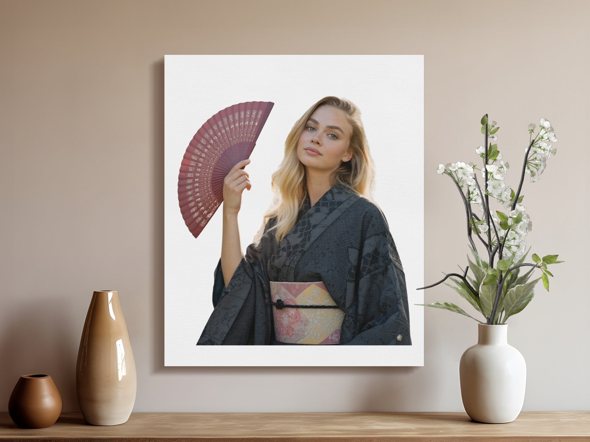 Young woman in dark kimono holding a red fan, against a white background.