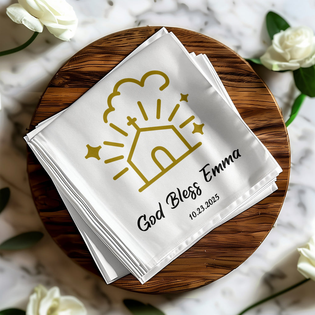 White napkin with gold design "God Bless Emma" and date, on wooden board.