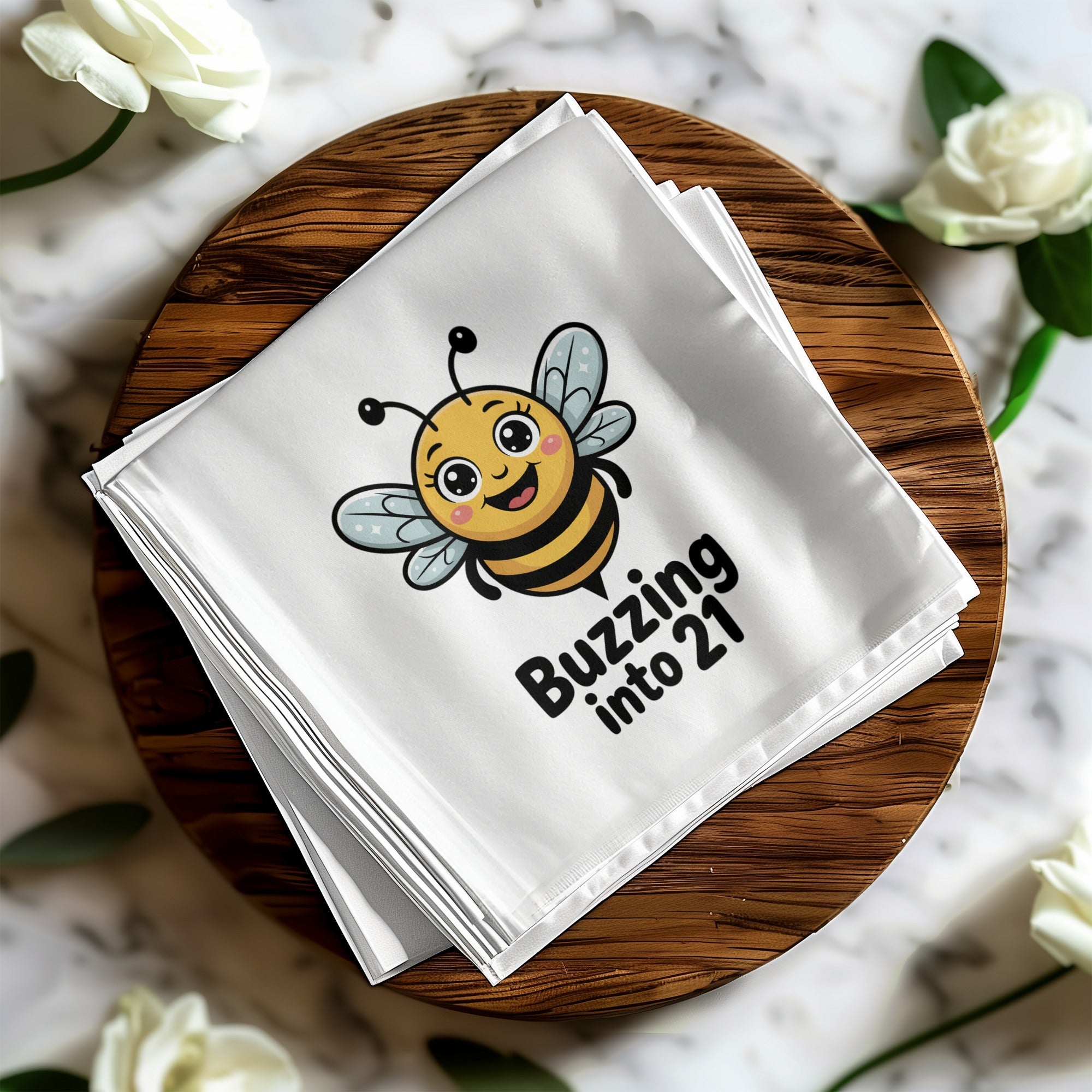 White cloth napkin with a cartoon bee saying "Buzzing into 21".