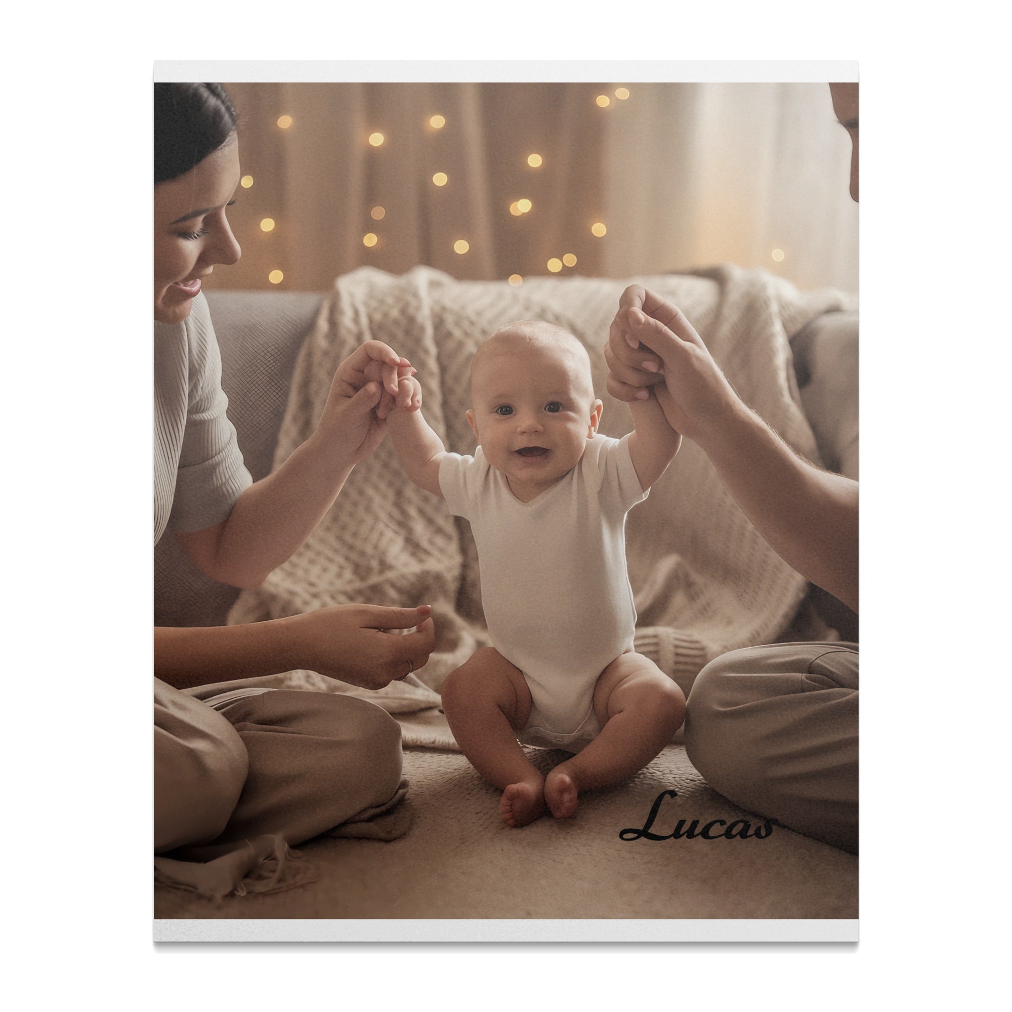 Baby in white onesie held by parents' hands, with "Lucas" text.