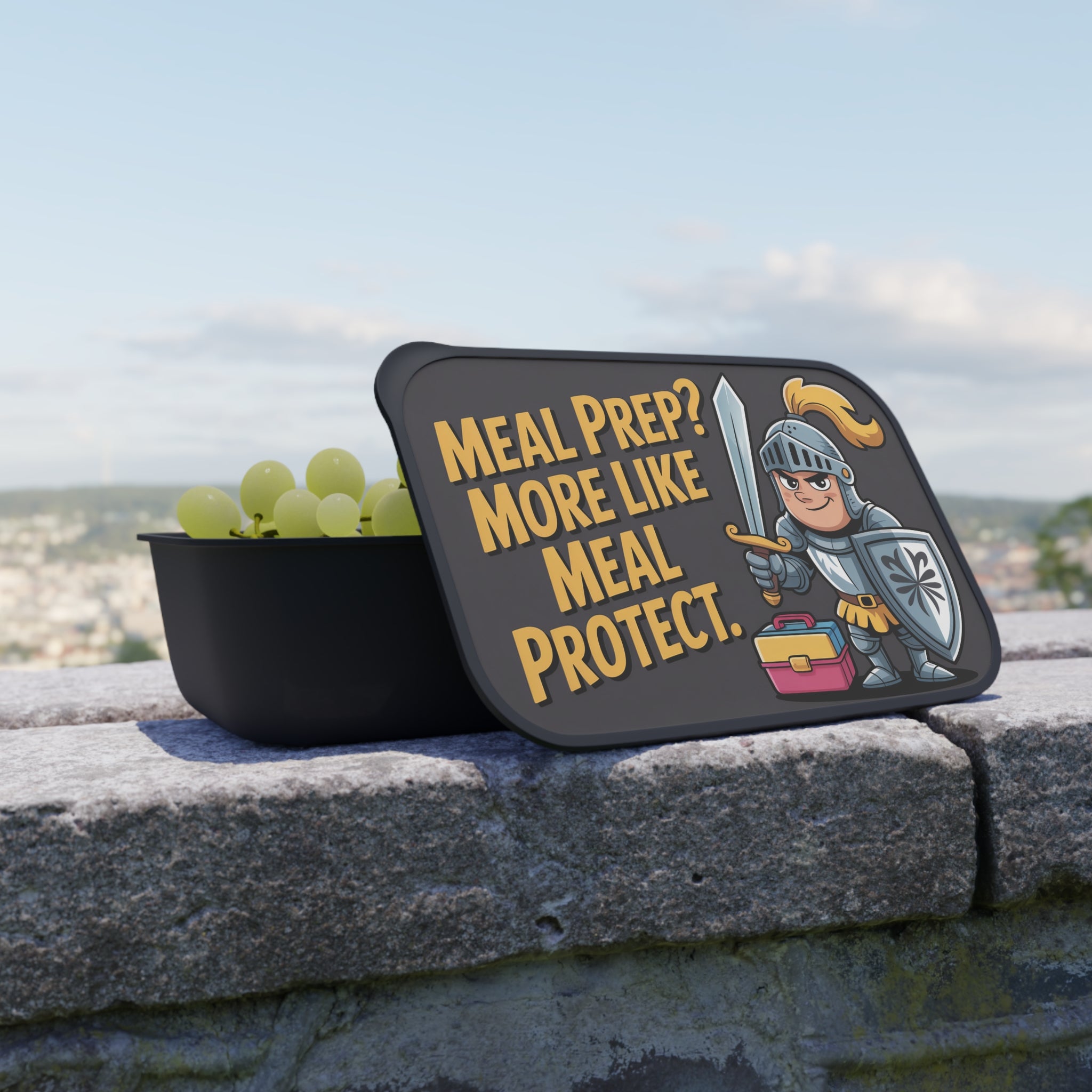 Meal prep container with humorous slogan and cartoon knight guarding grapes.