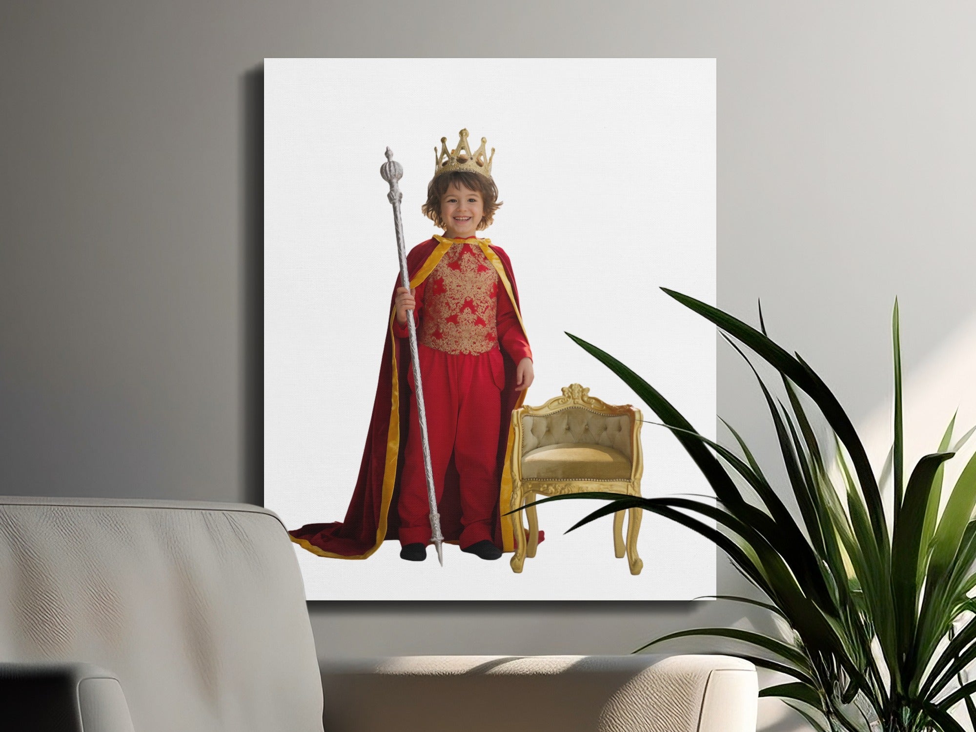 Young boy in king's costume with crown and scepter stands by ornate chair.