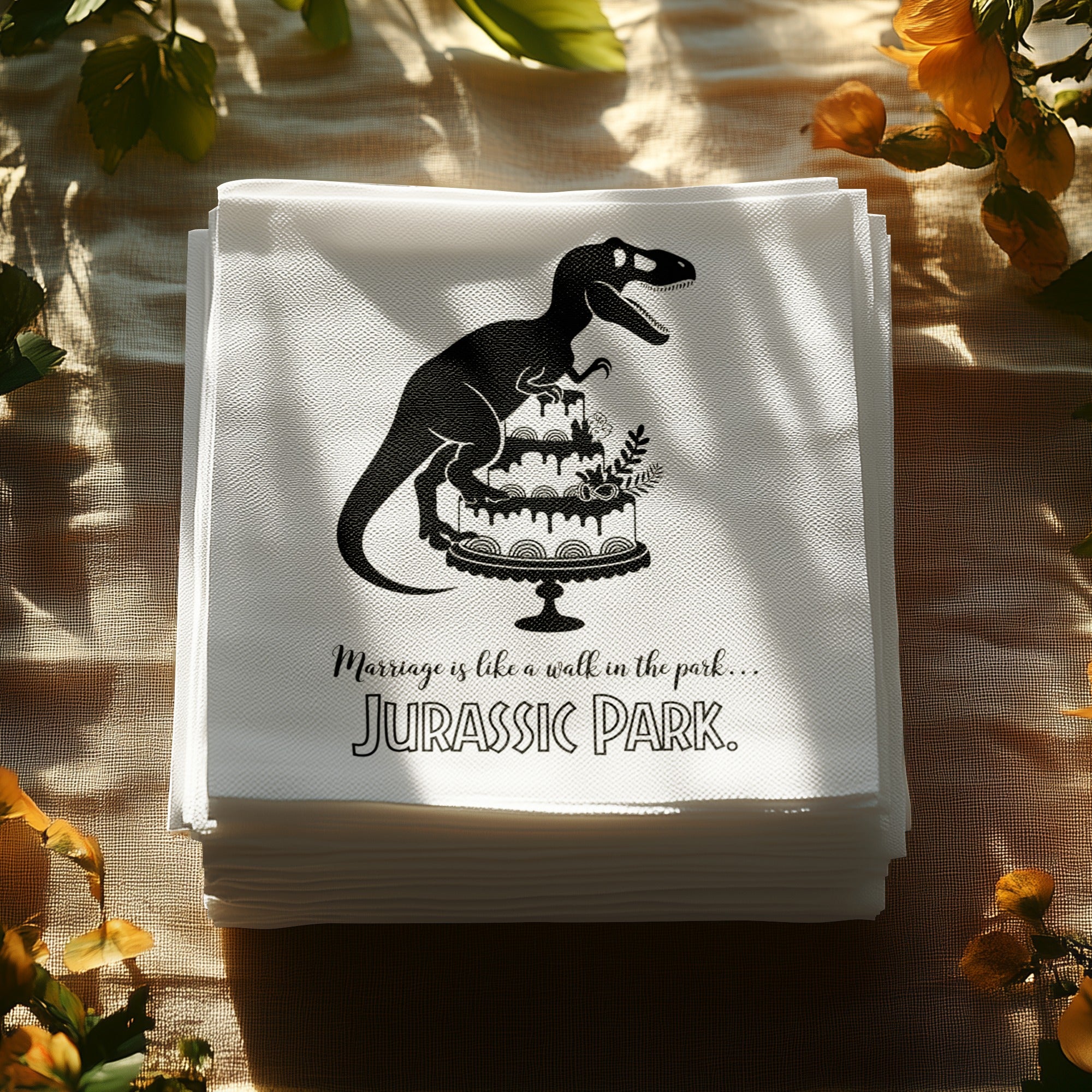 Napkins with a Jurassic Park T-Rex on a cake and text.