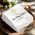 Stack of white napkins with gold cross and "God Bless Emma 10.23.2025".